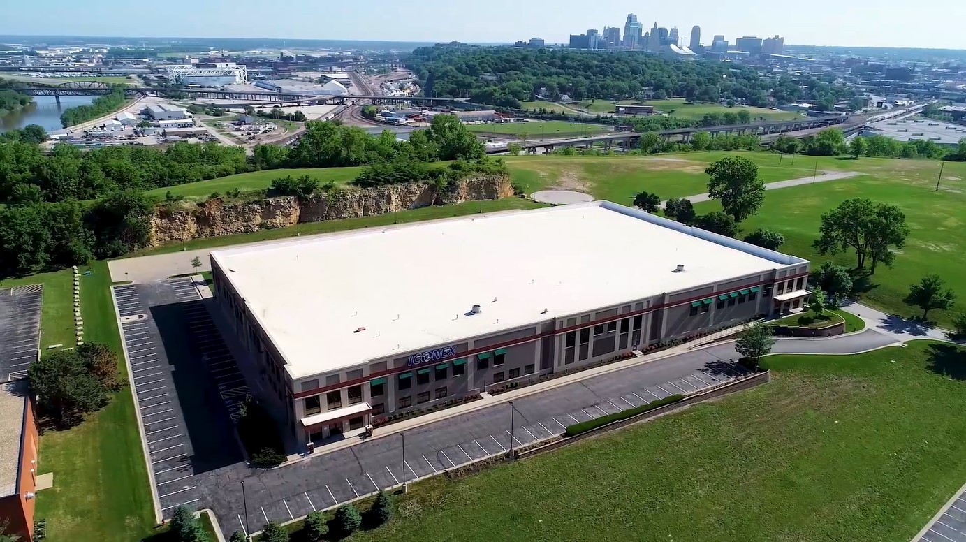 Top of a building with the river on one side and the city skyline on the other in the back